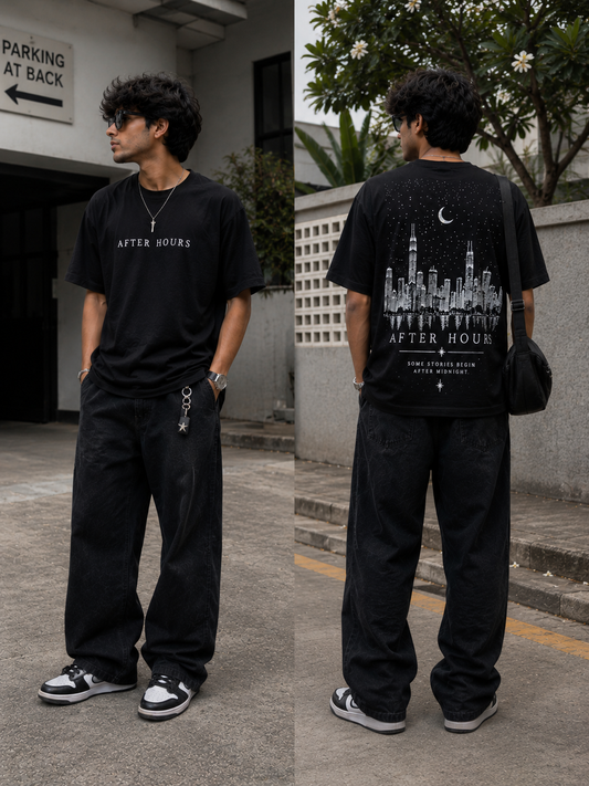 Person wearing a black 'AFTER HOURS' t-shirt with a cityscape design on the back, standing outdoors.